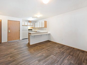 View of kitchen from living room at Boardwalk Senior Apartments